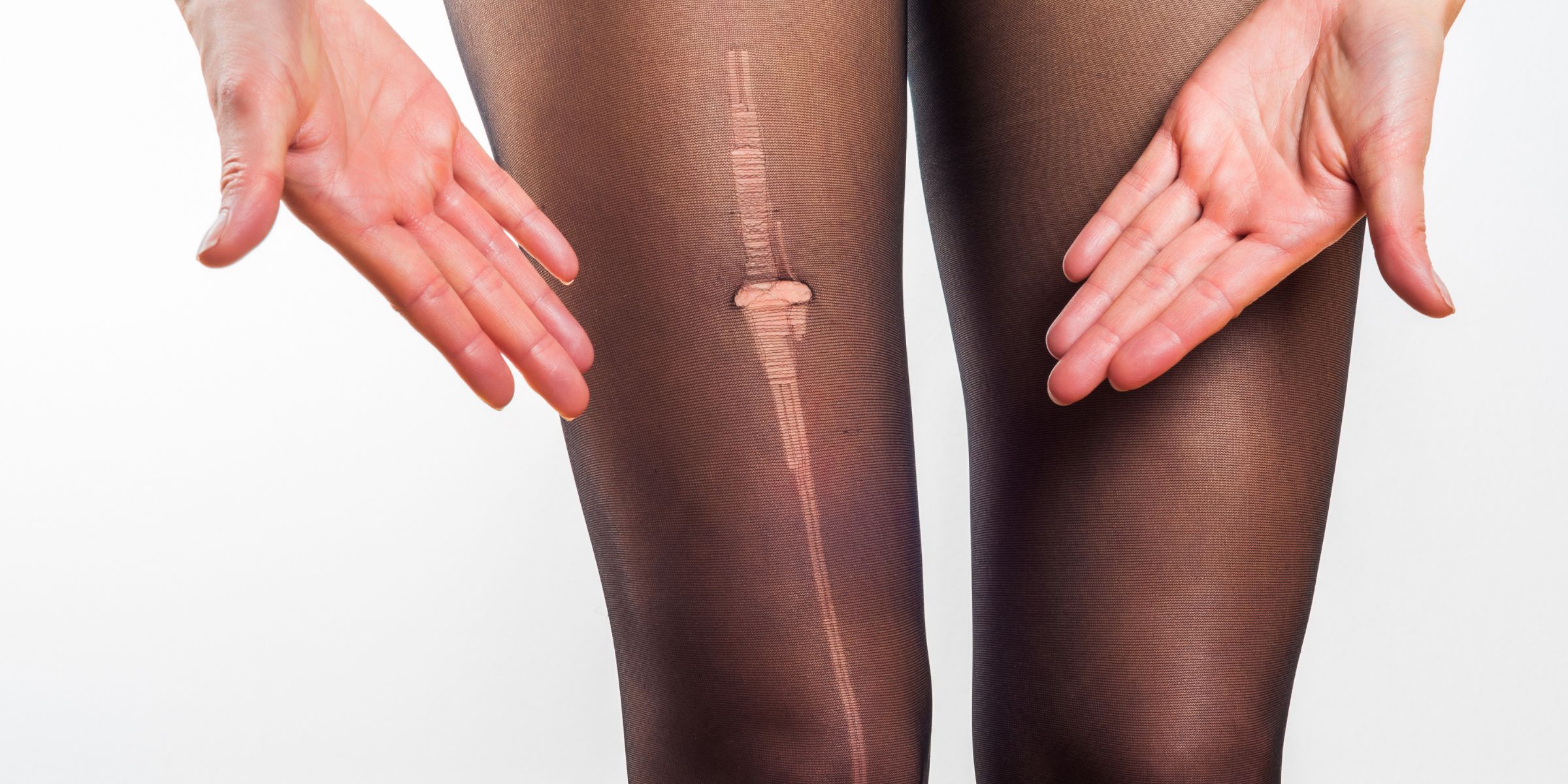 A woman showing where her tights laddered | Source: Getty Images