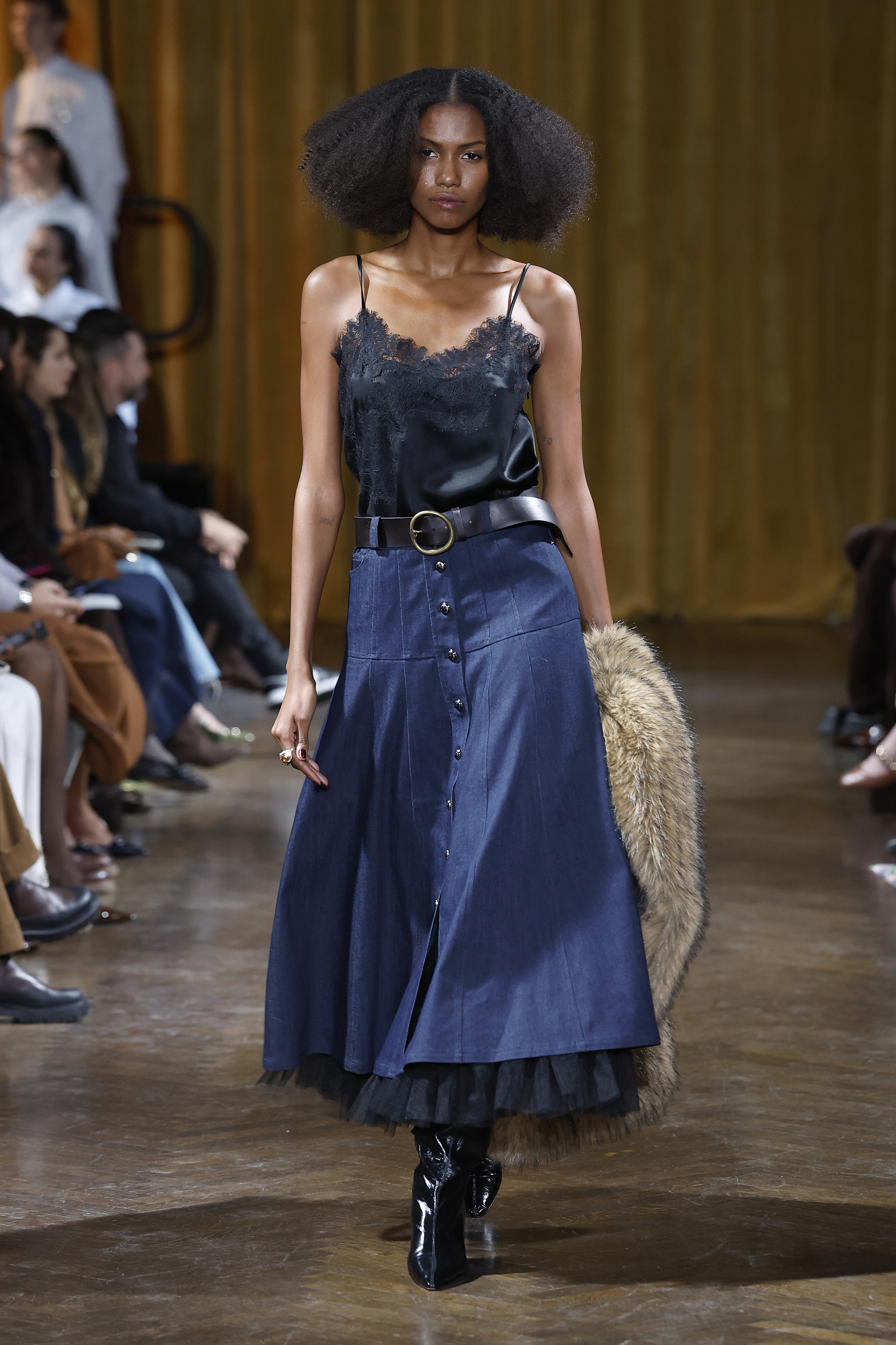 A model walks the runway in a denim skirt at the Cinq a Sept show during New York Fashion Week in February 2026 | Source: Getty Images