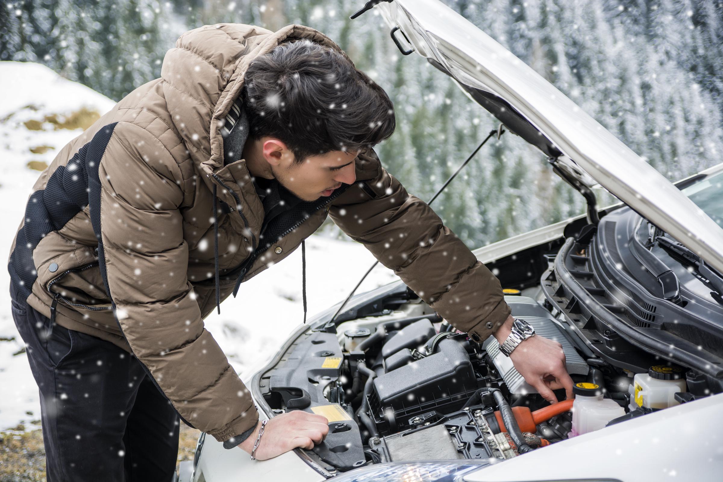 A young man inspecting his car engine | Source: Getty Images