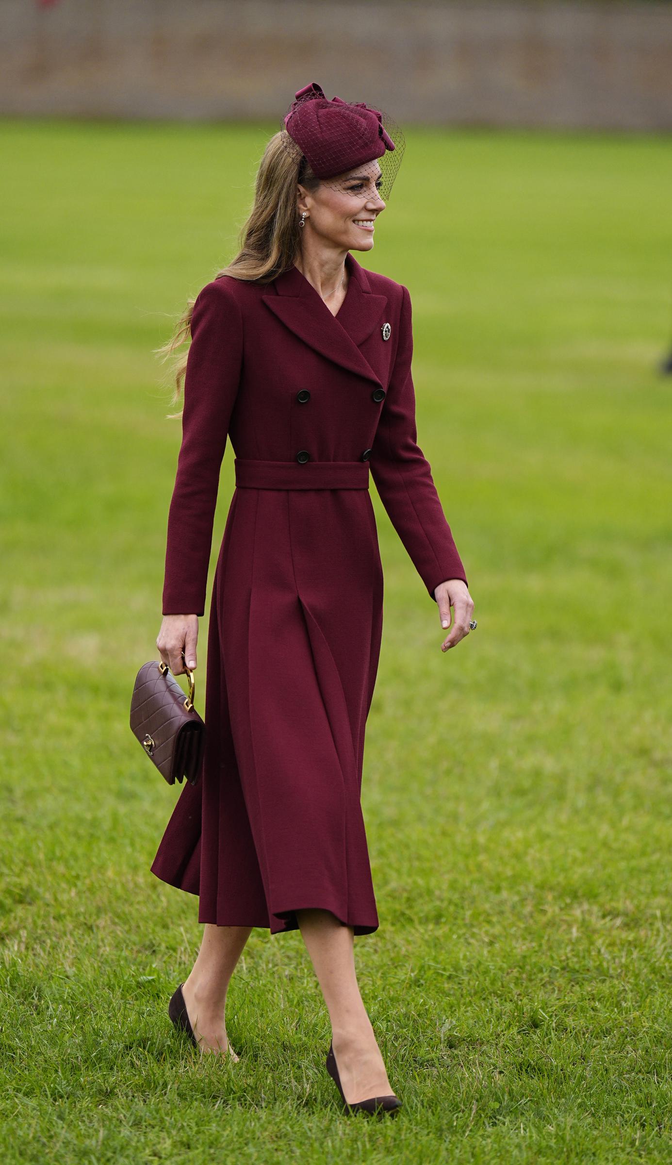 Catherine, Princess of Wales, arrives on the grounds of the Windsor Estate in Windsor on September 17, 2025, for the ceremonial welcome marking the start of U.S. President Donald Trump's state visit. Dressed in rich autumnal tones, Catherine wears a tailored burgundy double-breasted coatdress with a belted waist and pleated skirt, styled with a matching netted fascinator, suede pointed-toe pumps, and a quilted Chanel handbag featuring a gold top handle. | Source: Getty Images