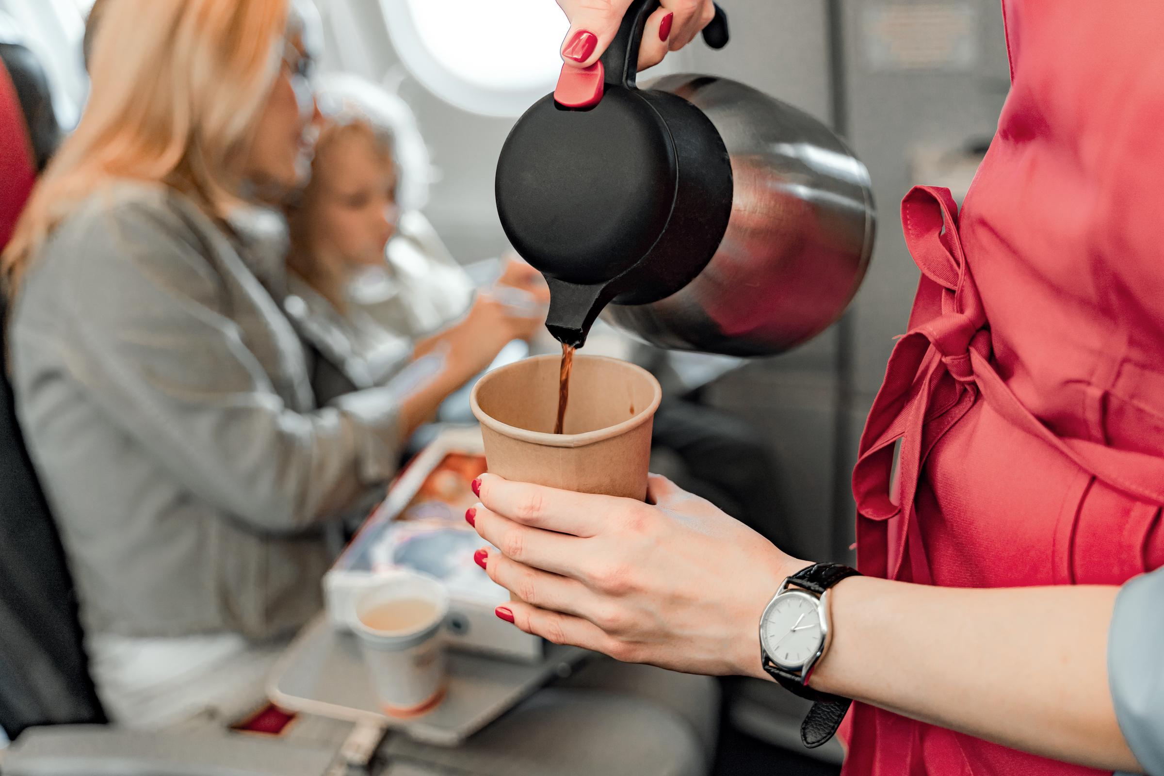 A stewardess pouring a cup of coffee | Source: Getty Images