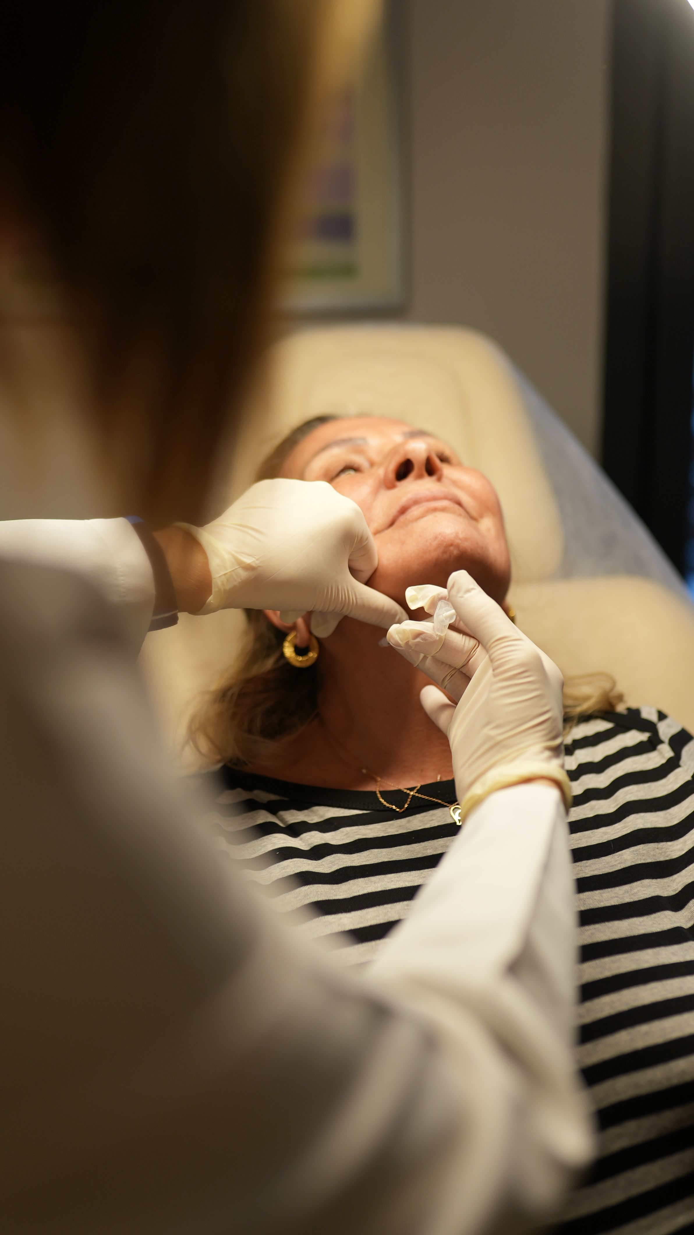 A person receiving cosmetic treatment on the neck | Source: Pexels