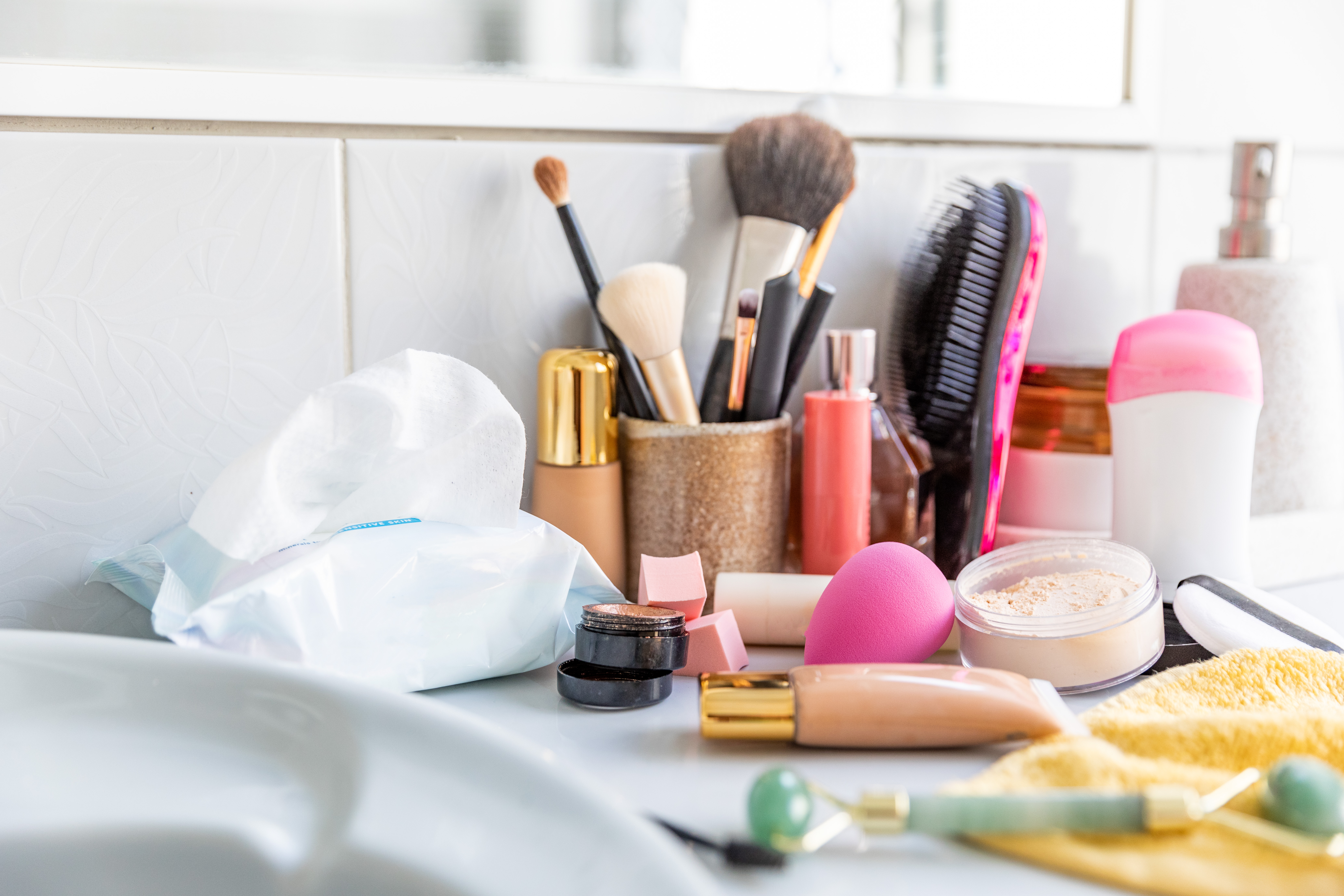 Cosmetics scattered on a bathroom counter | Source: Getty Images