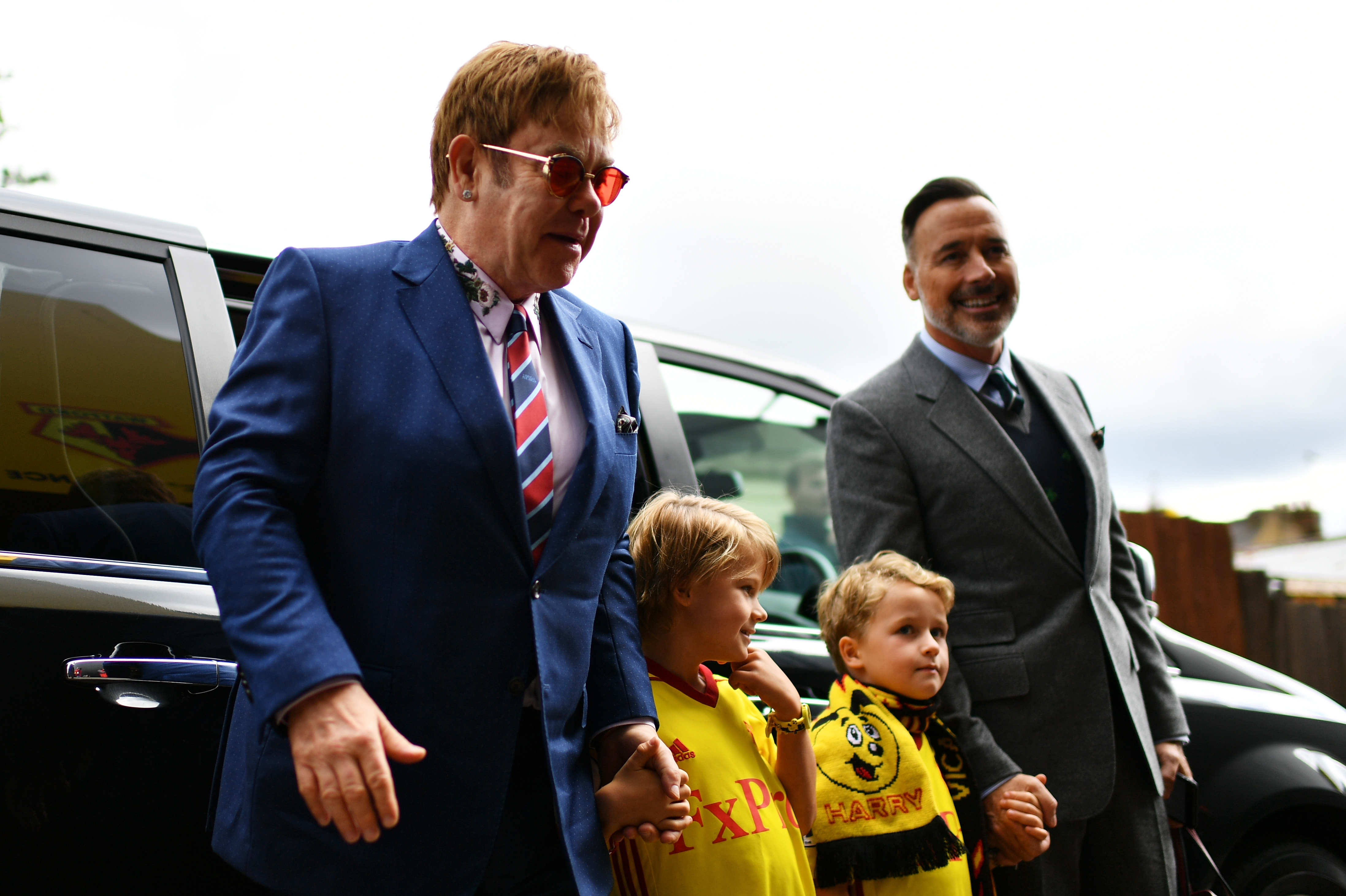 Elton John and David Furnish arrive with sons Zachary and Elijah at Vicarage Road Stadium for the Watford vs. Manchester City match, September 16, 2017 | Source: Getty Images
