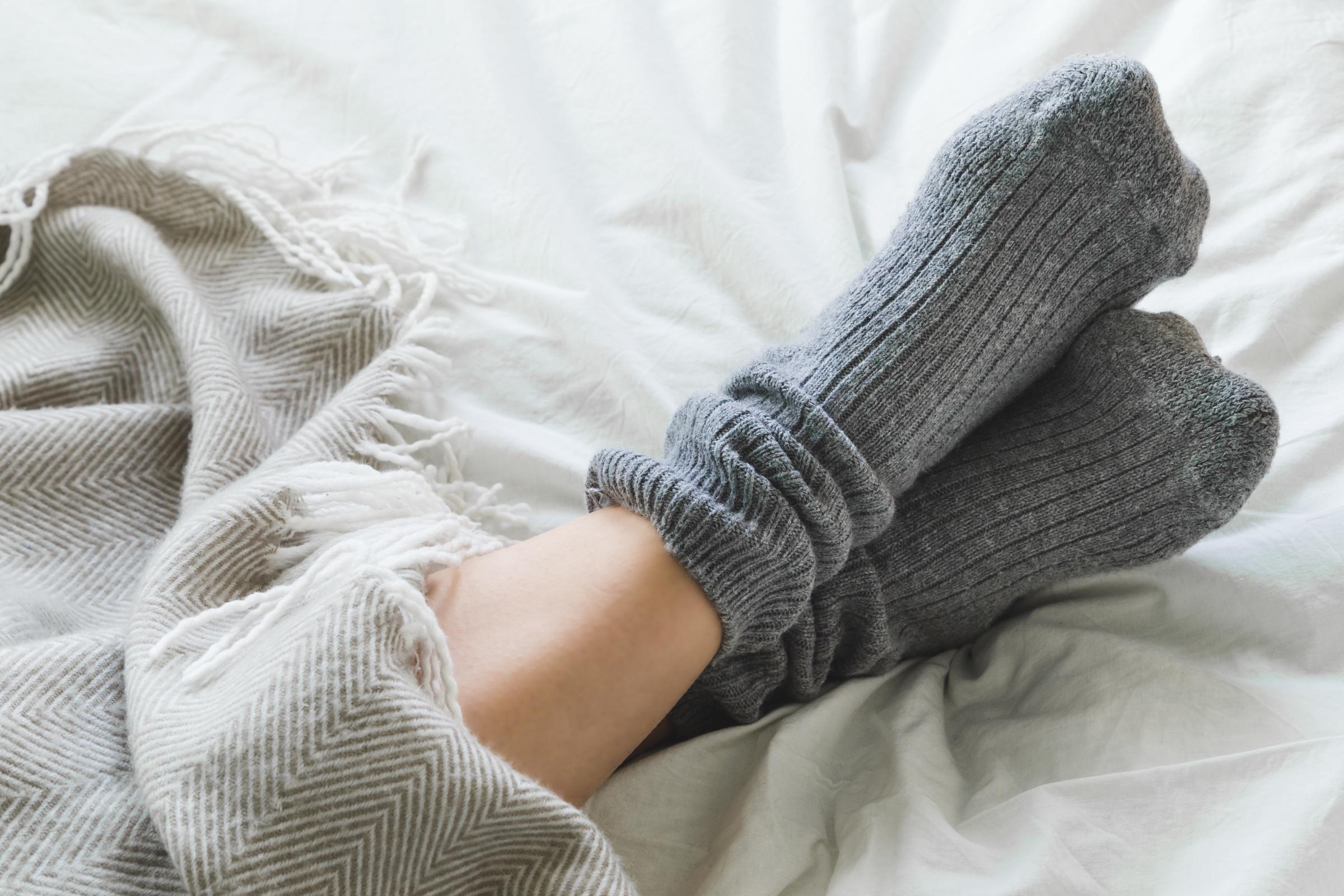 A pair of feet with socks on | Source: Getty Images