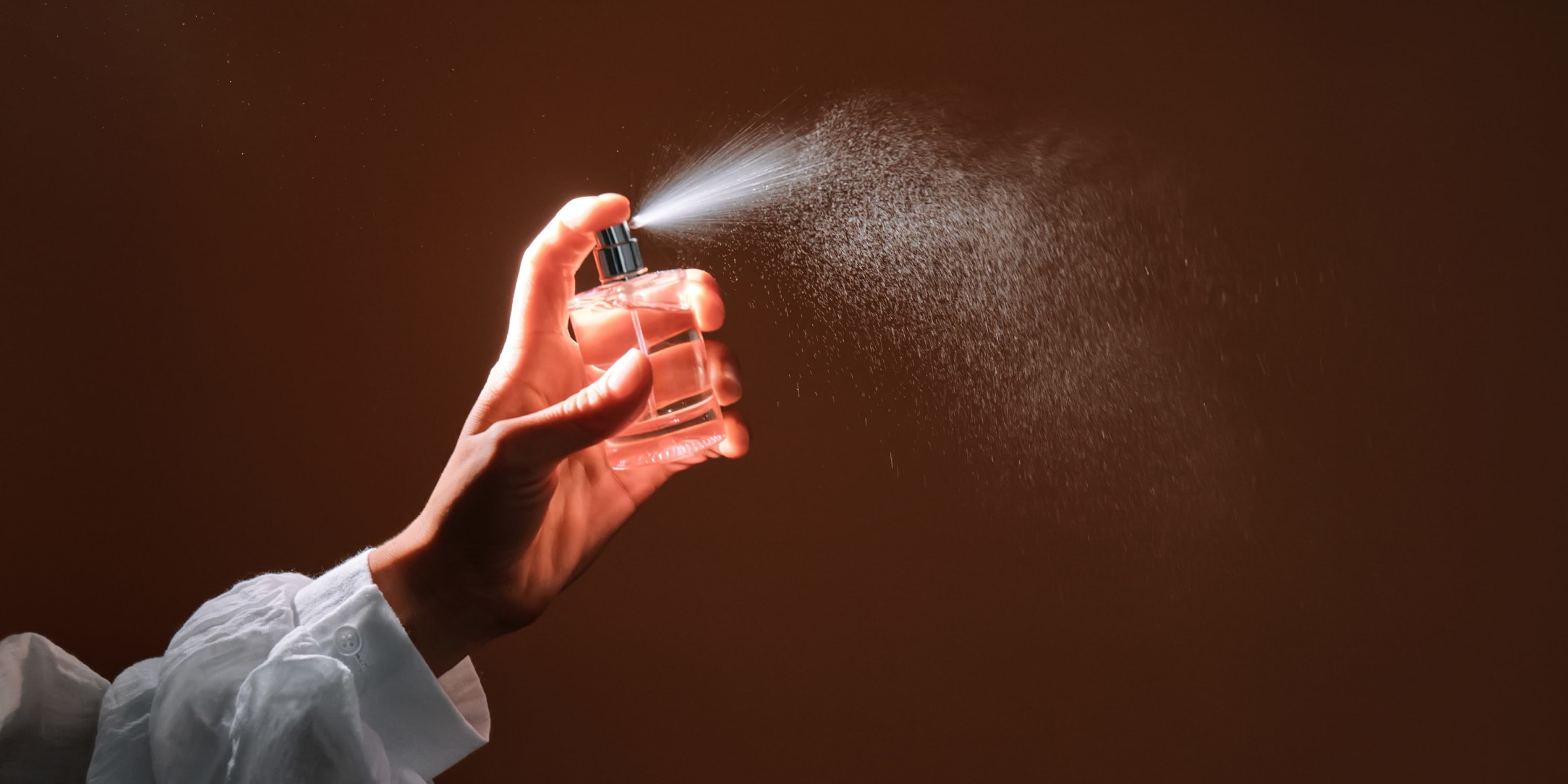 A woman spritzing perfume into the air | Source: Getty Images