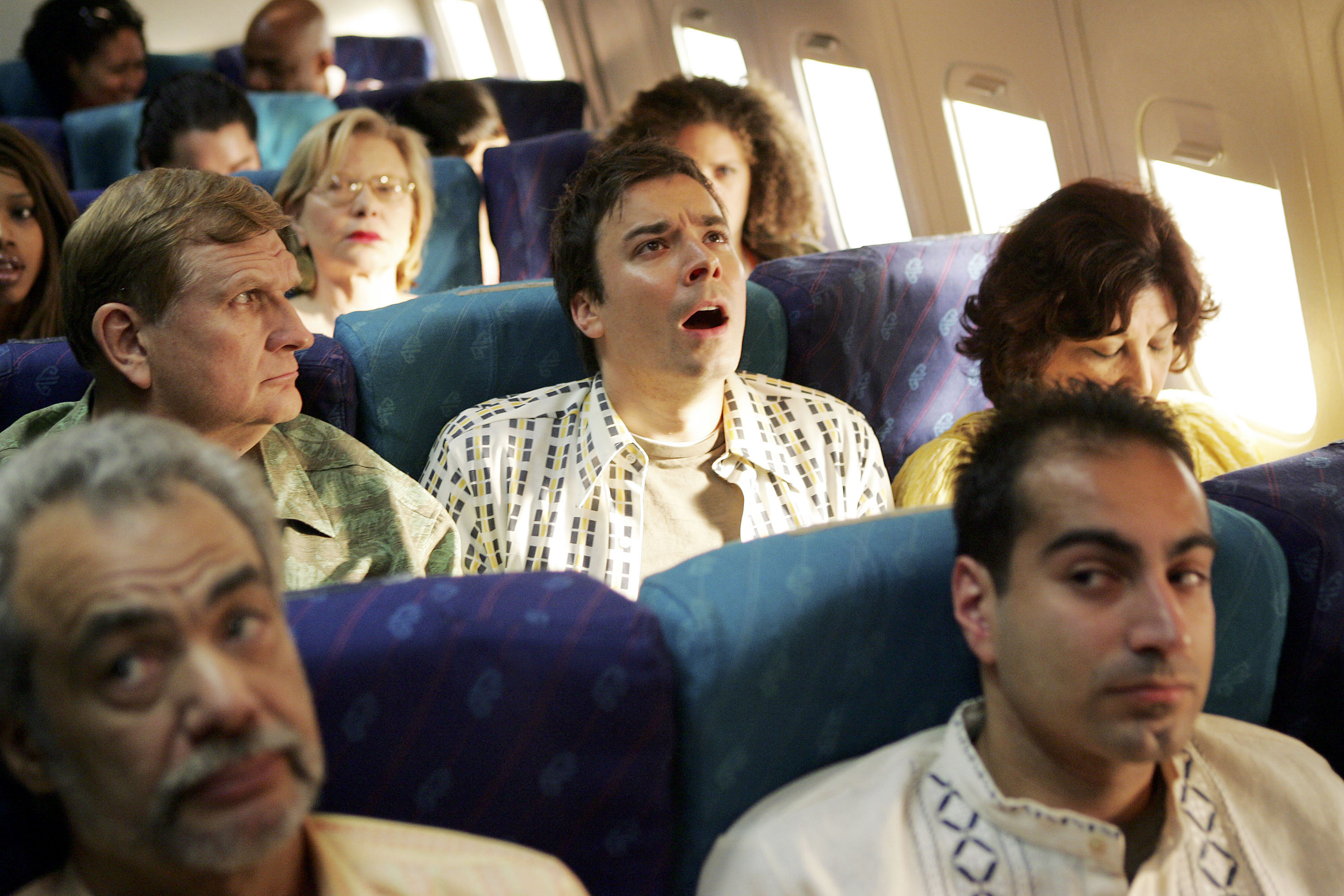 Jimmy Fallon seated at the middle seat of a plane while promoting the 2005 MTV Movie Awards at Paris Studios May 16, 2005 | Soruce: Getty Images
