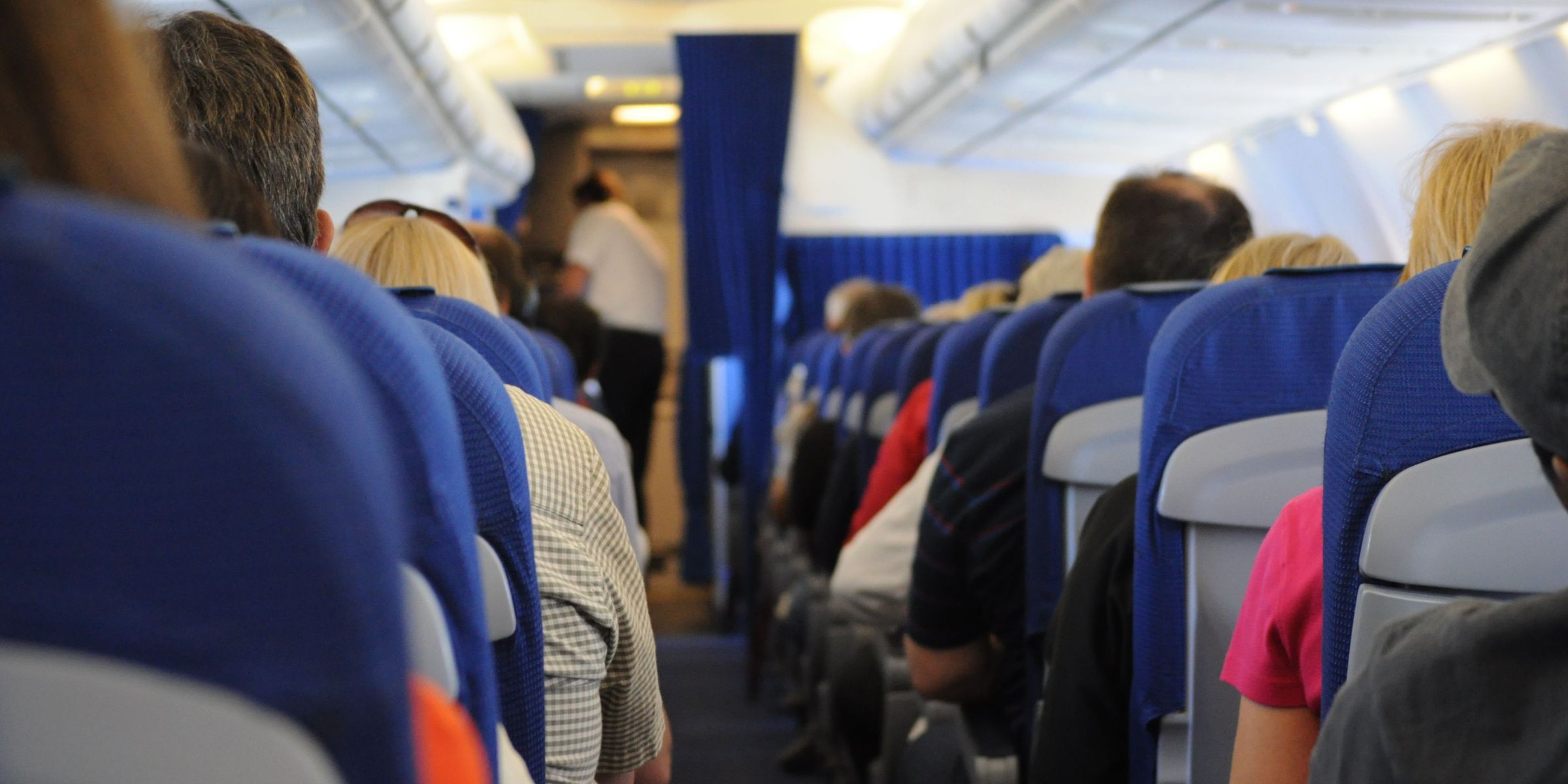 Passengers seated in the economy class of an airplane | Source: Pexels