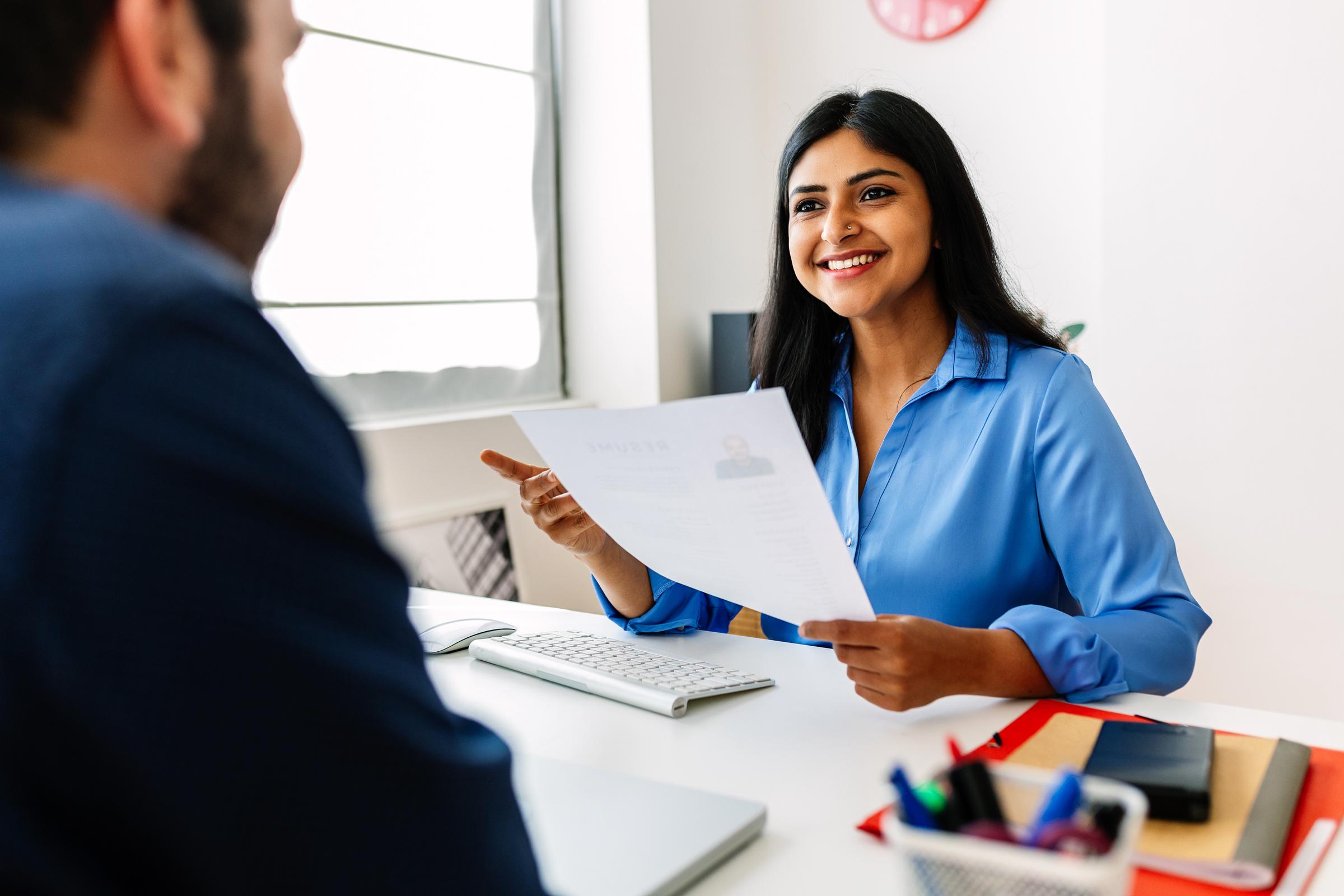 A hiring manager speaking to a job candidate | Source: Getty Images