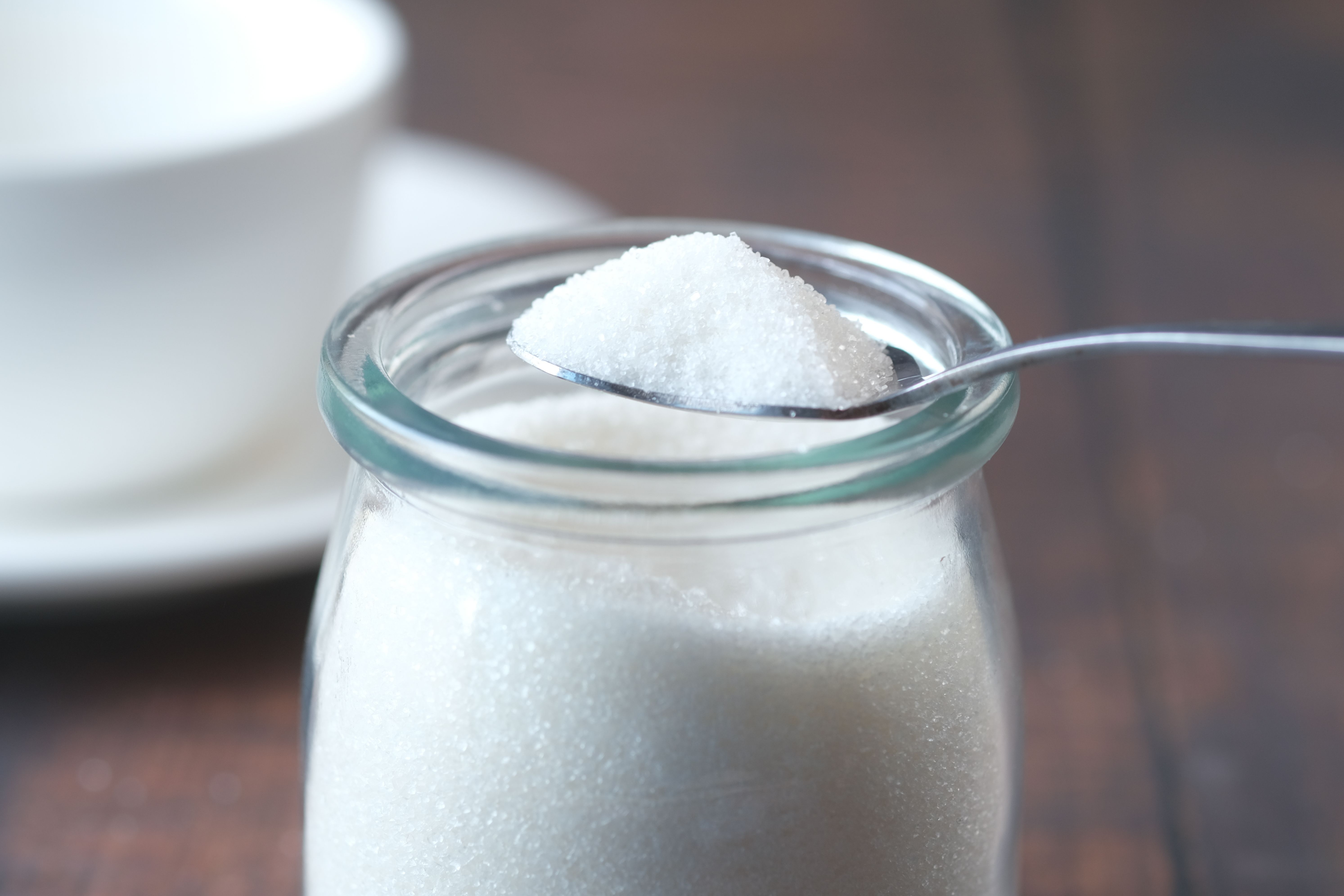 A spoon scooping sugar out of a jar | Source: Pexels