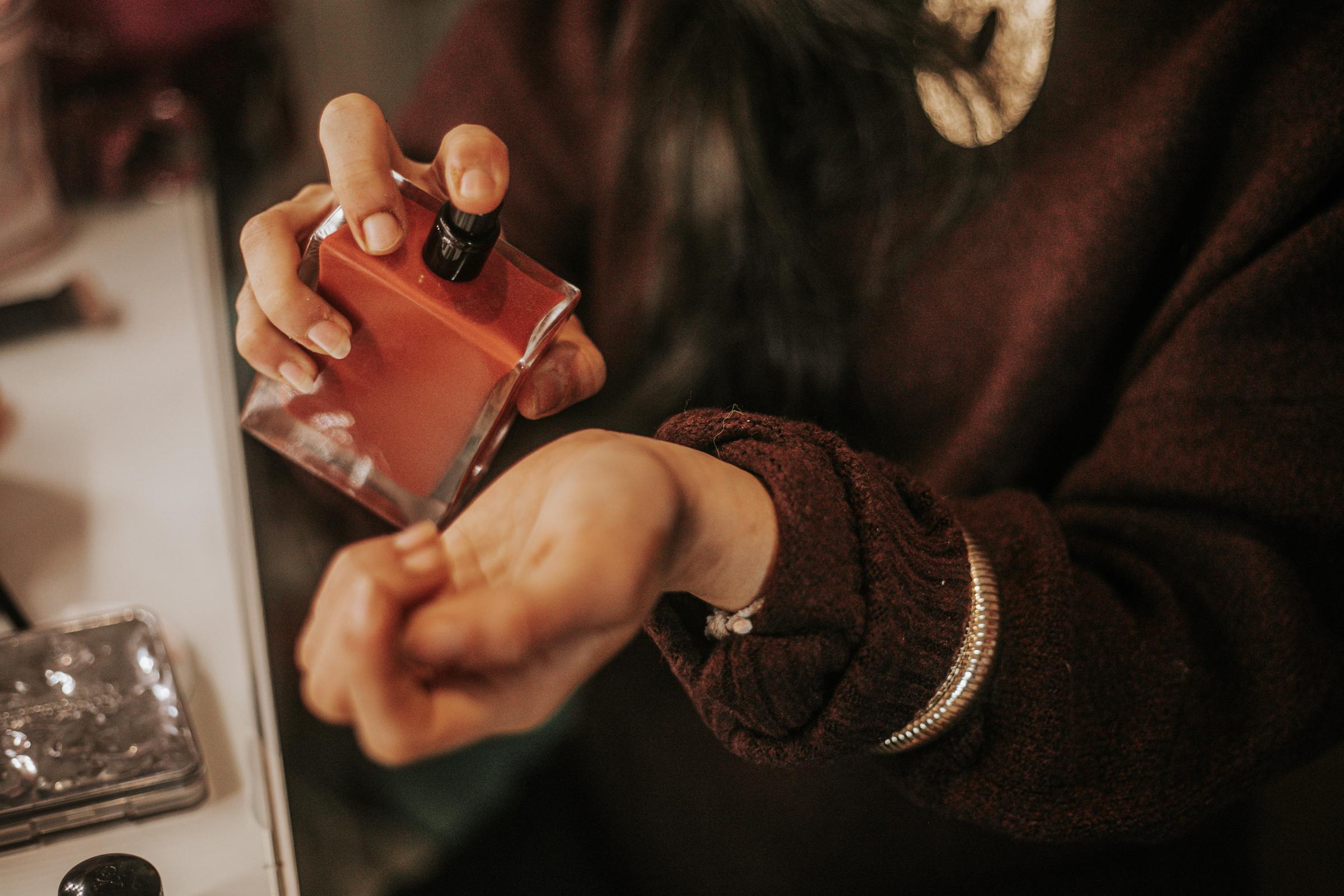 A woman applying perfume on her wrist | Source: Getty Images
