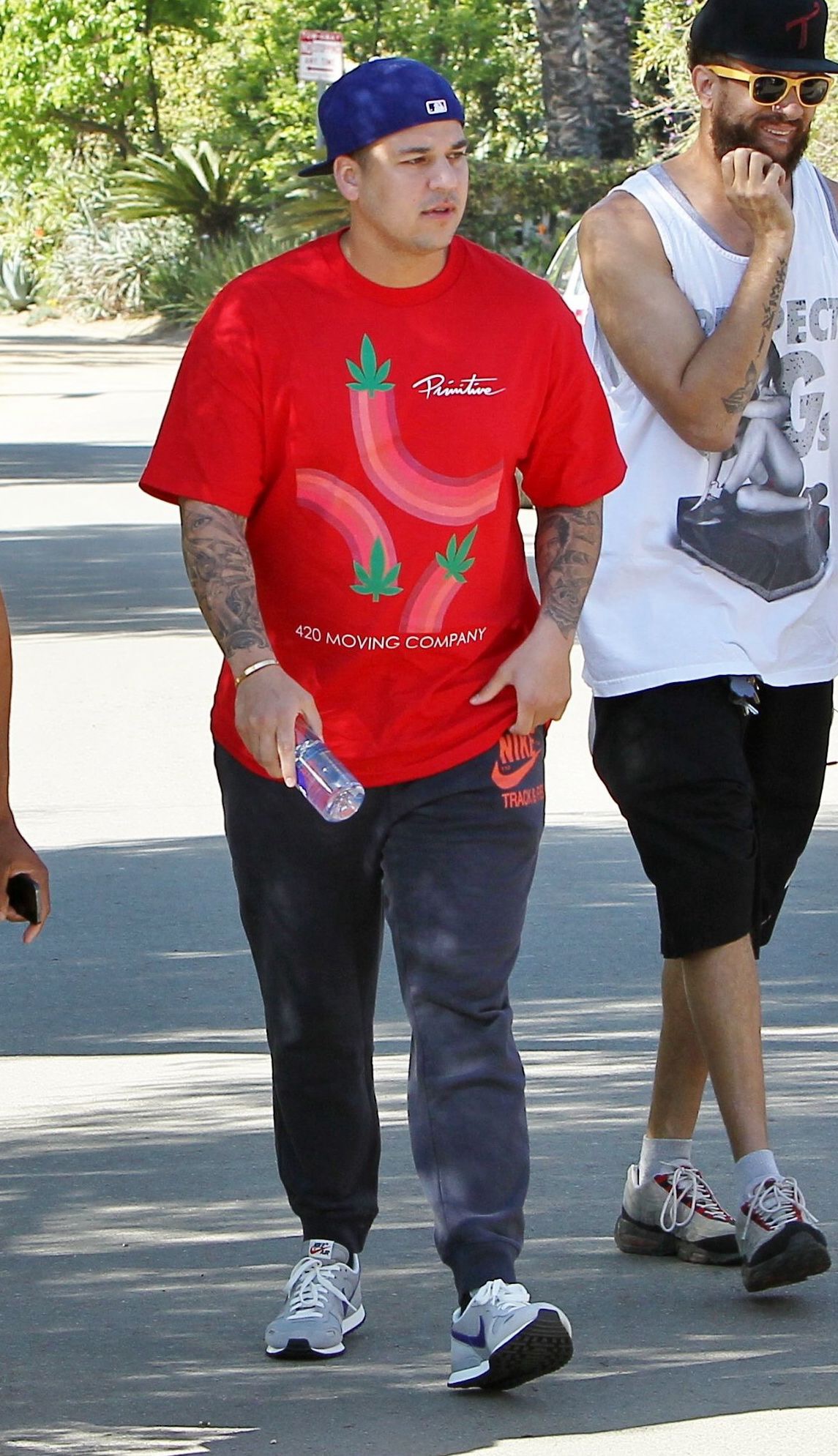 Rob Kardashian is pictured wearing a red T-shirt and blue baseball cap during a casual outing in 2015. At the time, he was rarely seen in public, while his family continued expressing concern about his withdrawal from the spotlight. | Source: Paparazzi photo.