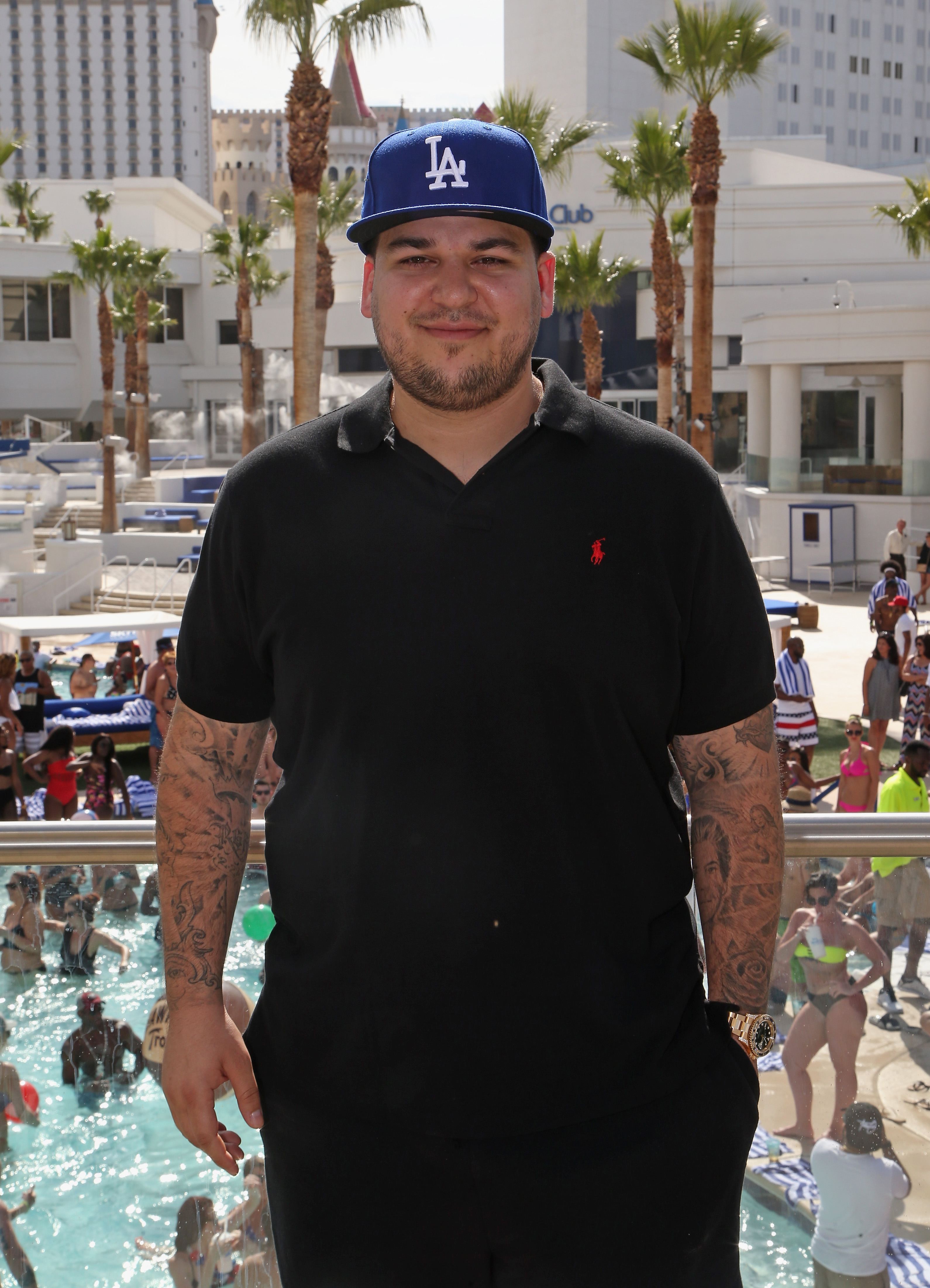 Rob Kardashian poses in a black polo shirt and LA baseball cap at Sky Beach Club in Las Vegas in May 2016. The appearance marked one of his rare returns to the public eye after years of struggling with body confidence and avoiding cameras. | Source: Getty Images.