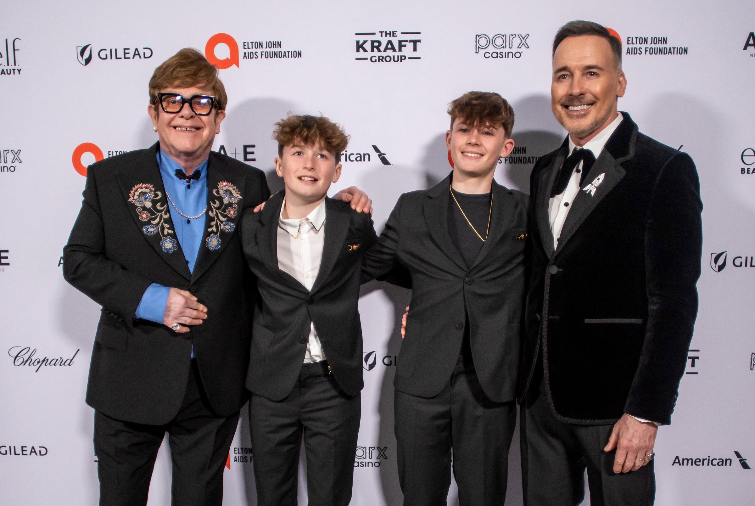 Elton John and David Furnish pose with sons Zachary and Elijah at the Elton John AIDS Foundation Oscars viewing party in West Hollywood, on March 2, 2025 | Source: Getty Images