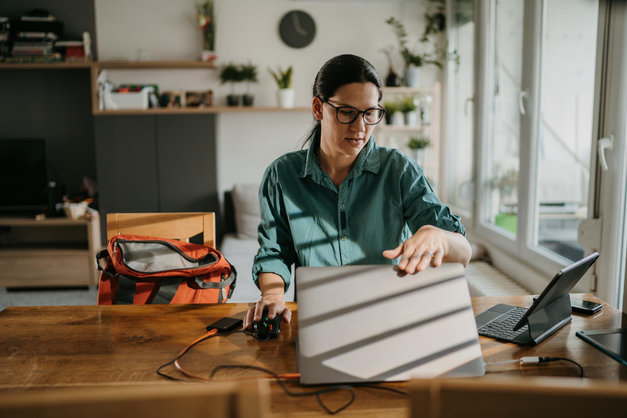 A woman closing her laptop after work | Source: Getty Images