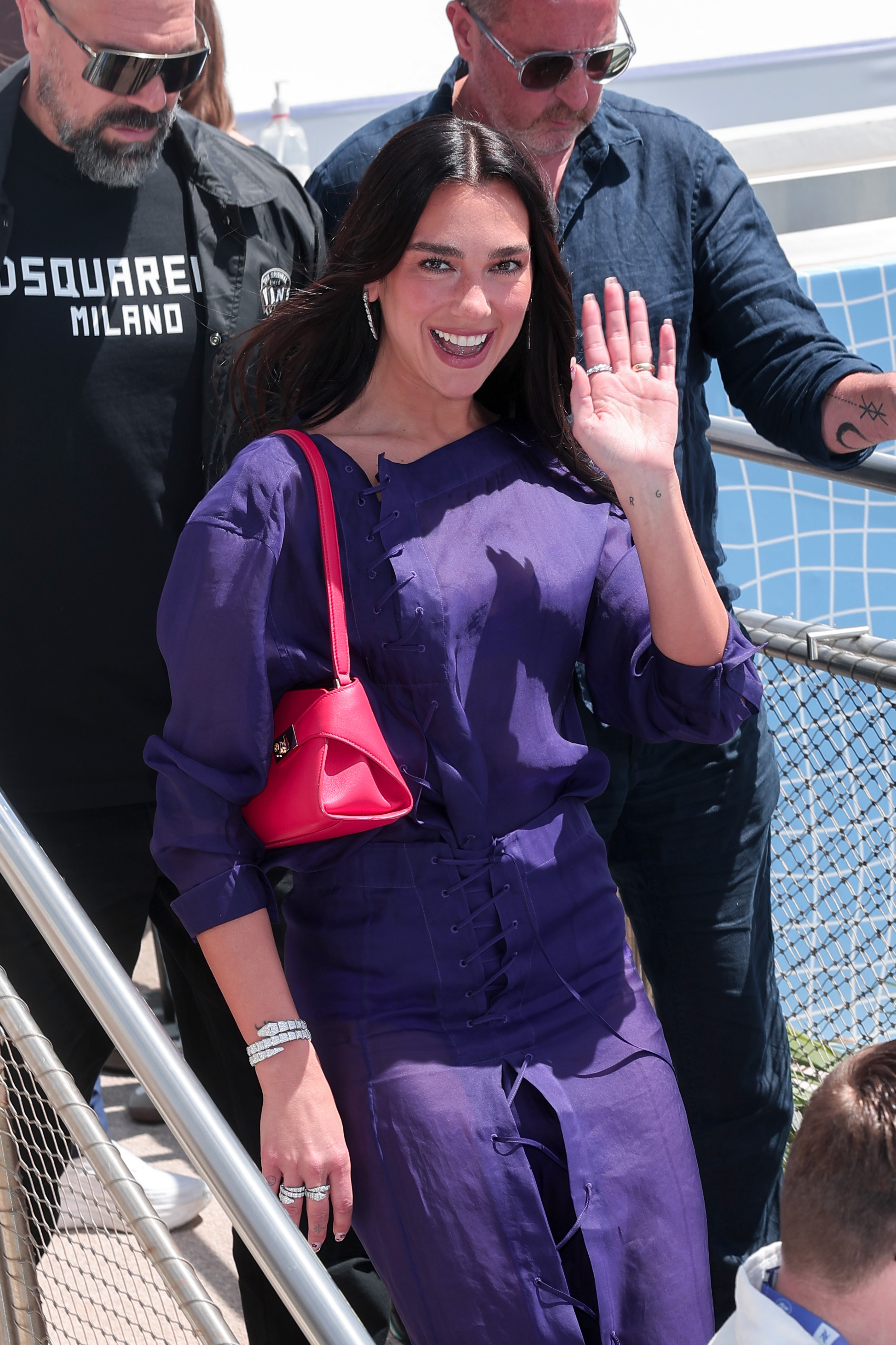 Dua Lipa stepping out in purple with a red bag during the 79th annual Cannes Film Festival on May 15, 2026 in Cannes, France| Source: Getty Images