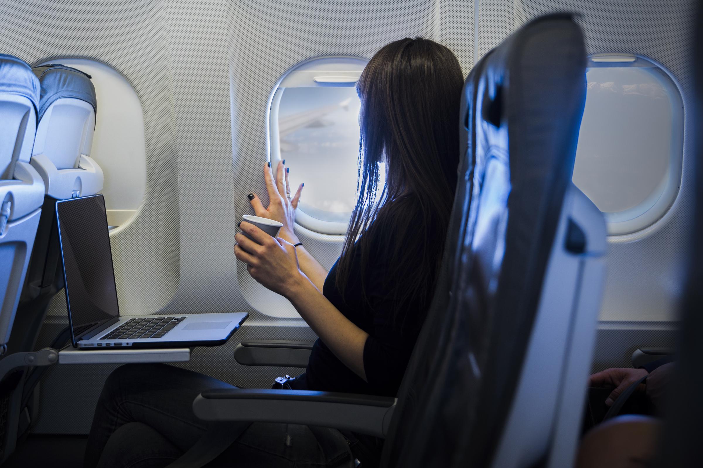A woman drinking coffee during a flight | Source: Getty Images