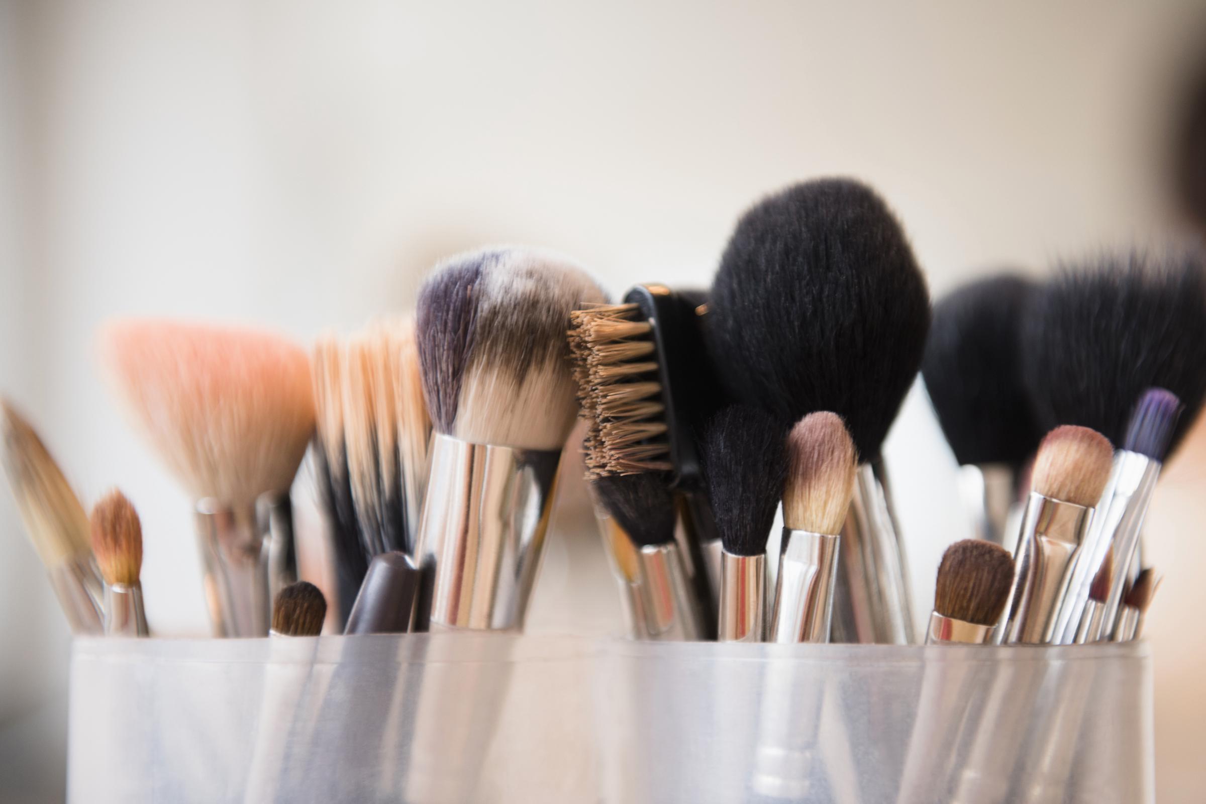 Makeup brushes in cups | Source: Getty Images