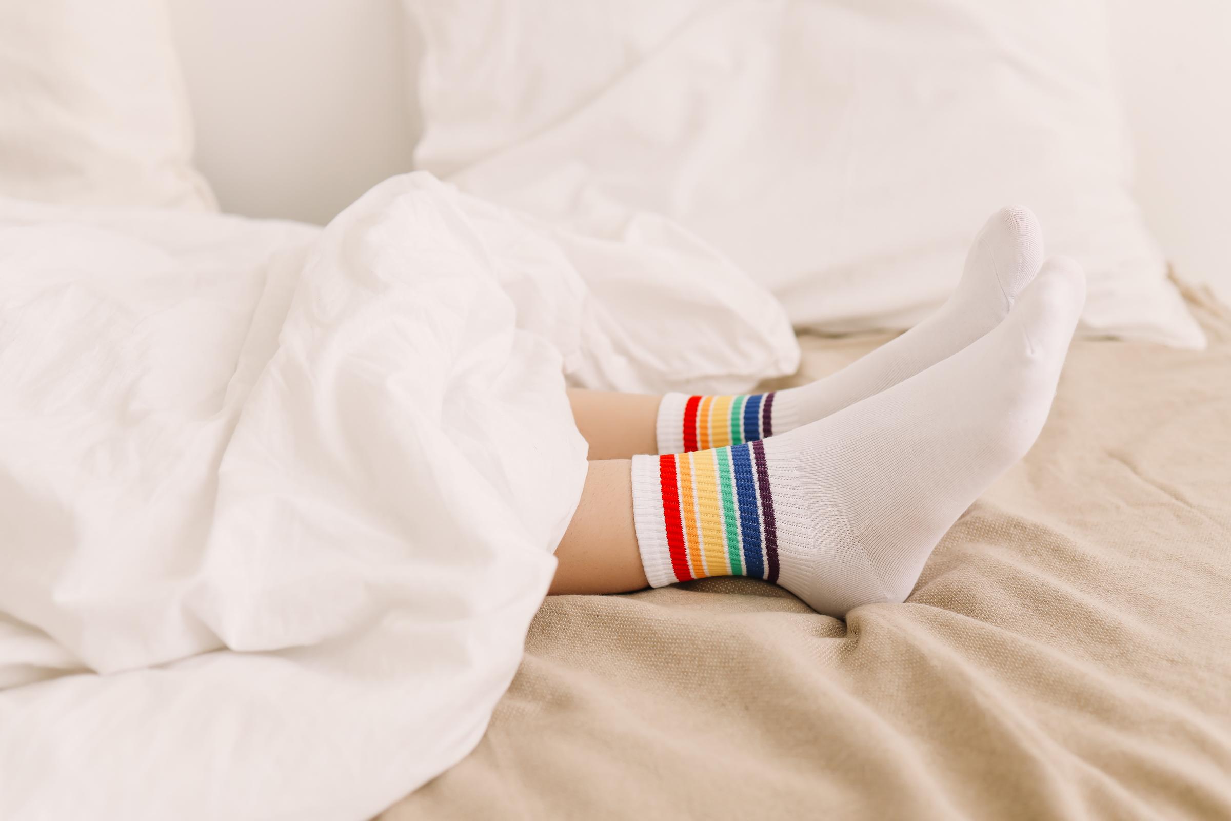 A person wearing socks in bed | Source: Getty Images