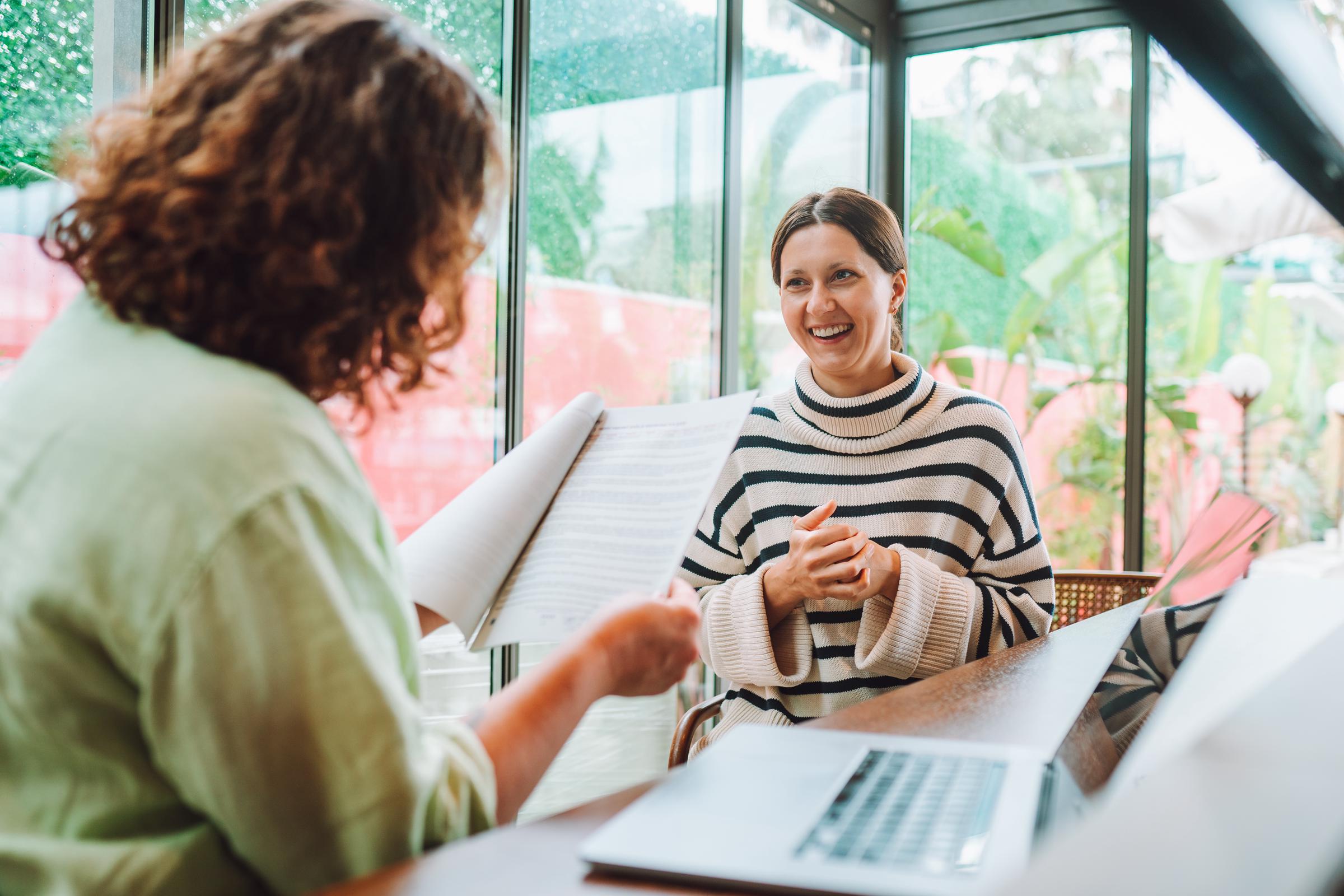A woman smiling while speaking to a hiring manager | Source: Getty Images