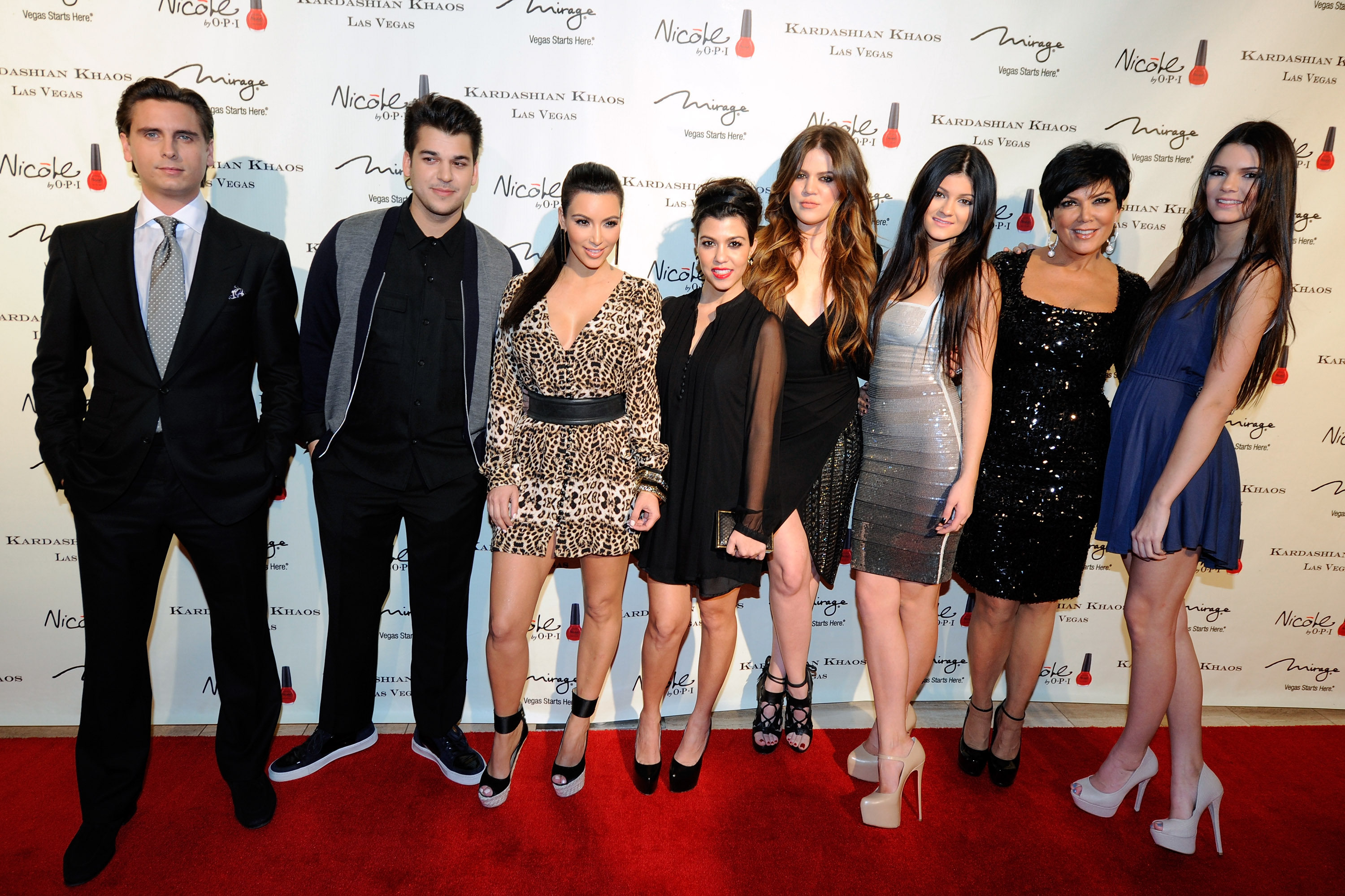 Rob Kardashian poses alongside Scott Disick, Kim, Kourtney, Khloé, Kylie, Kendall, and Kris Jenner at a Kardashian Khaos event in Las Vegas in 2011. The photograph captures a time when Rob regularly joined his entire family on the red carpet, years before he began avoiding public appearances. | Source: Getty Images.