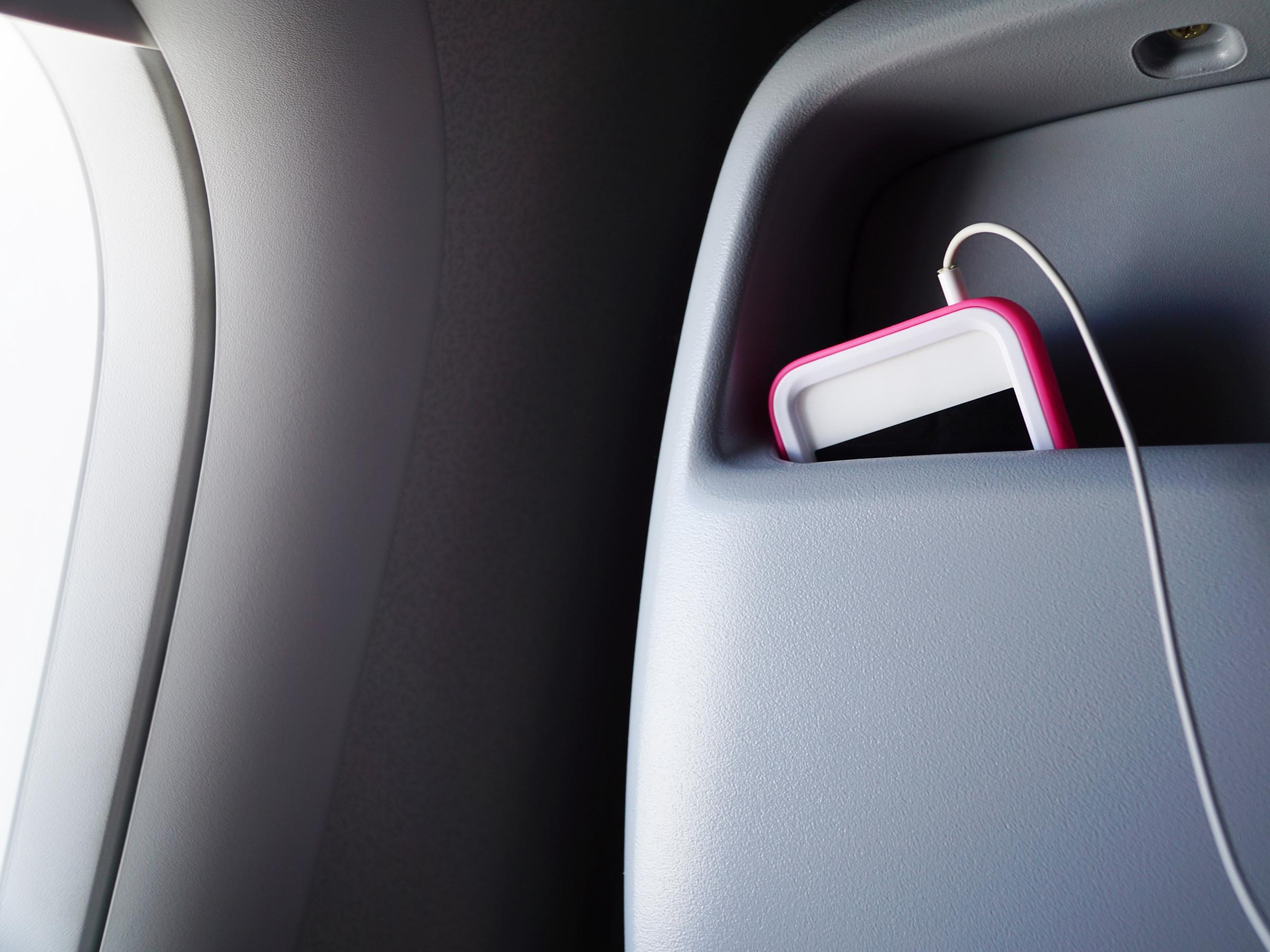 A phone tucked into the back seat pocket on a plane | Source: Getty Images